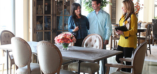 Customers looking at a dining room set at Furnitureland South