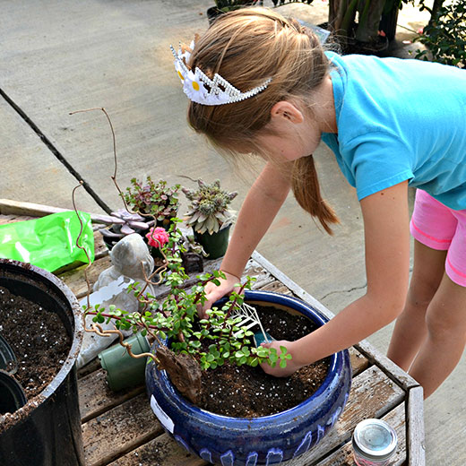 Young girl making a Fairy Garden