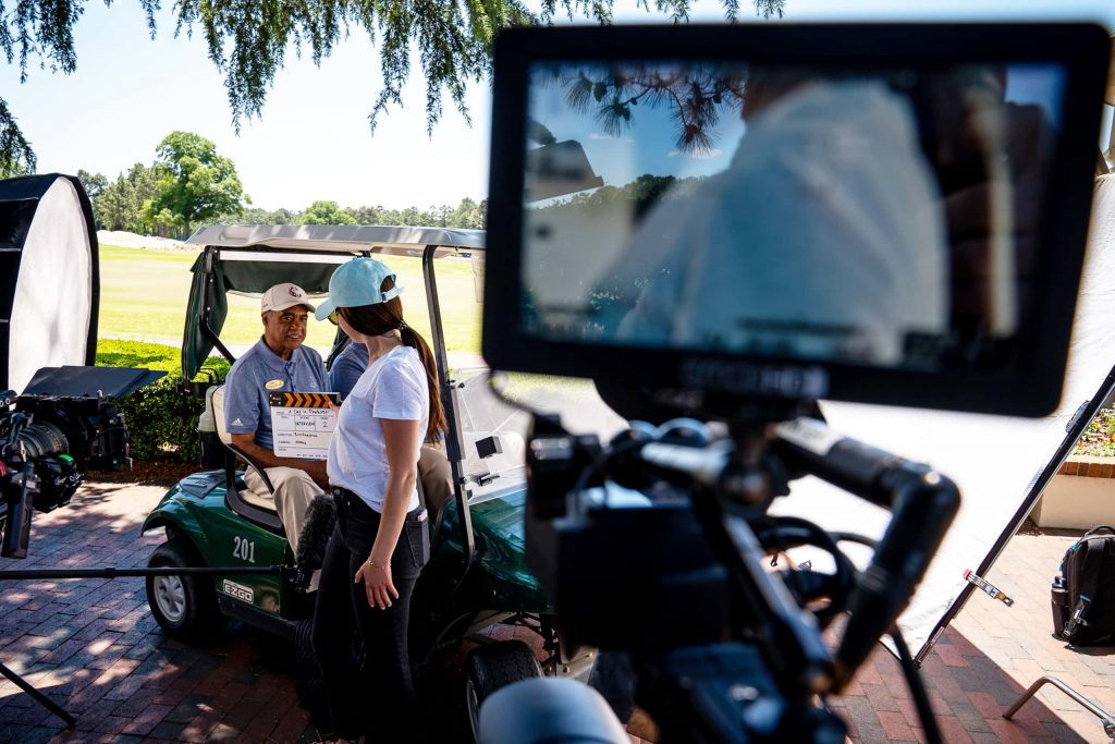 Behind the scenes video shoot at gold course with golf cart