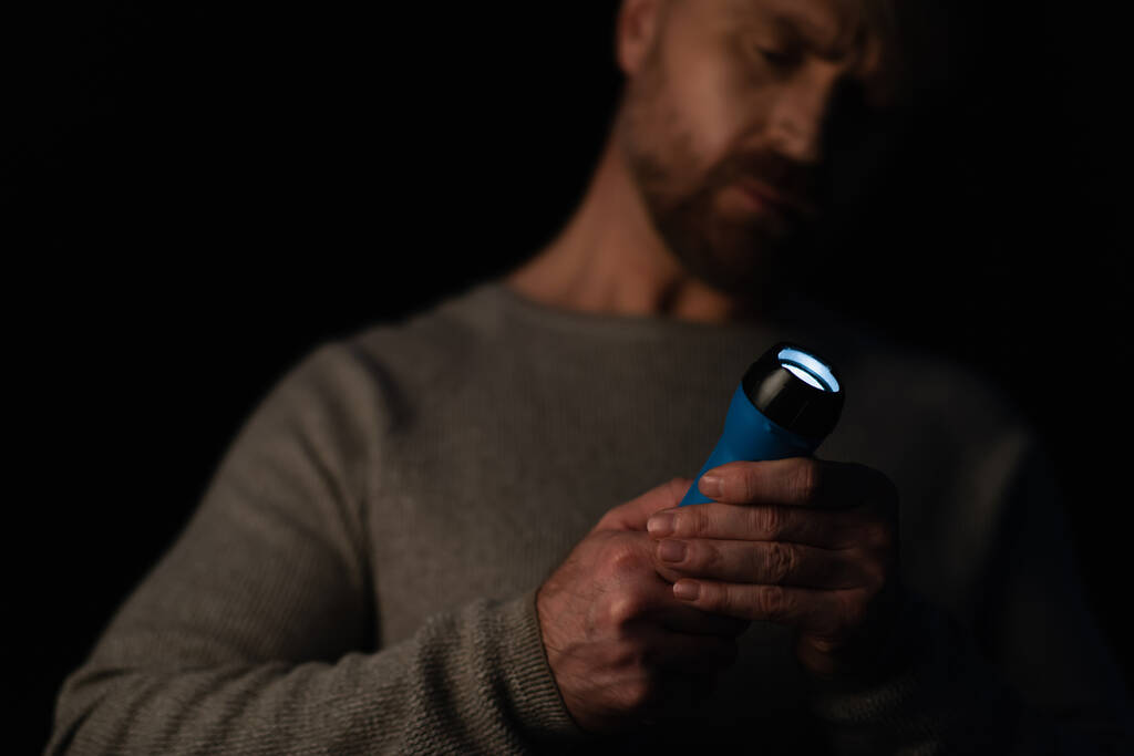 man holding flashlight