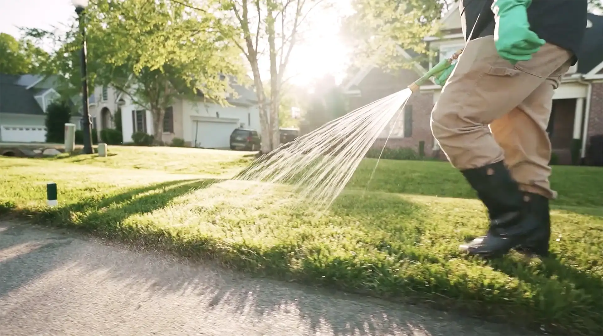 Barefoot law care sprinkling the lawn