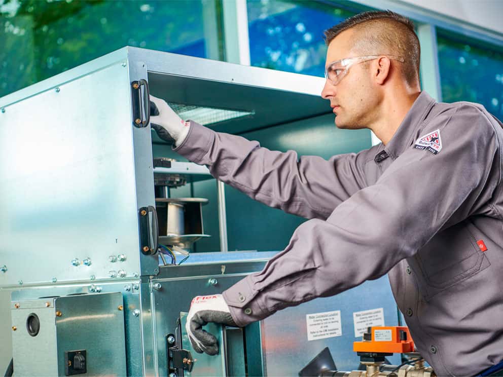 photo of a man working on machine equipment
