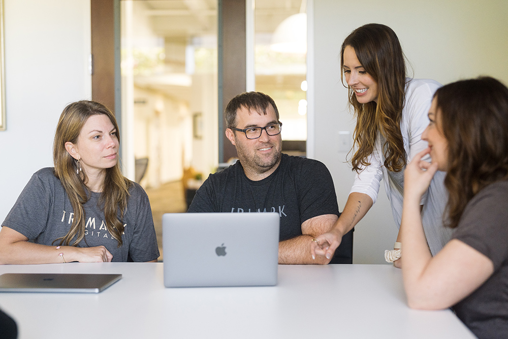 Image of team working around a computer